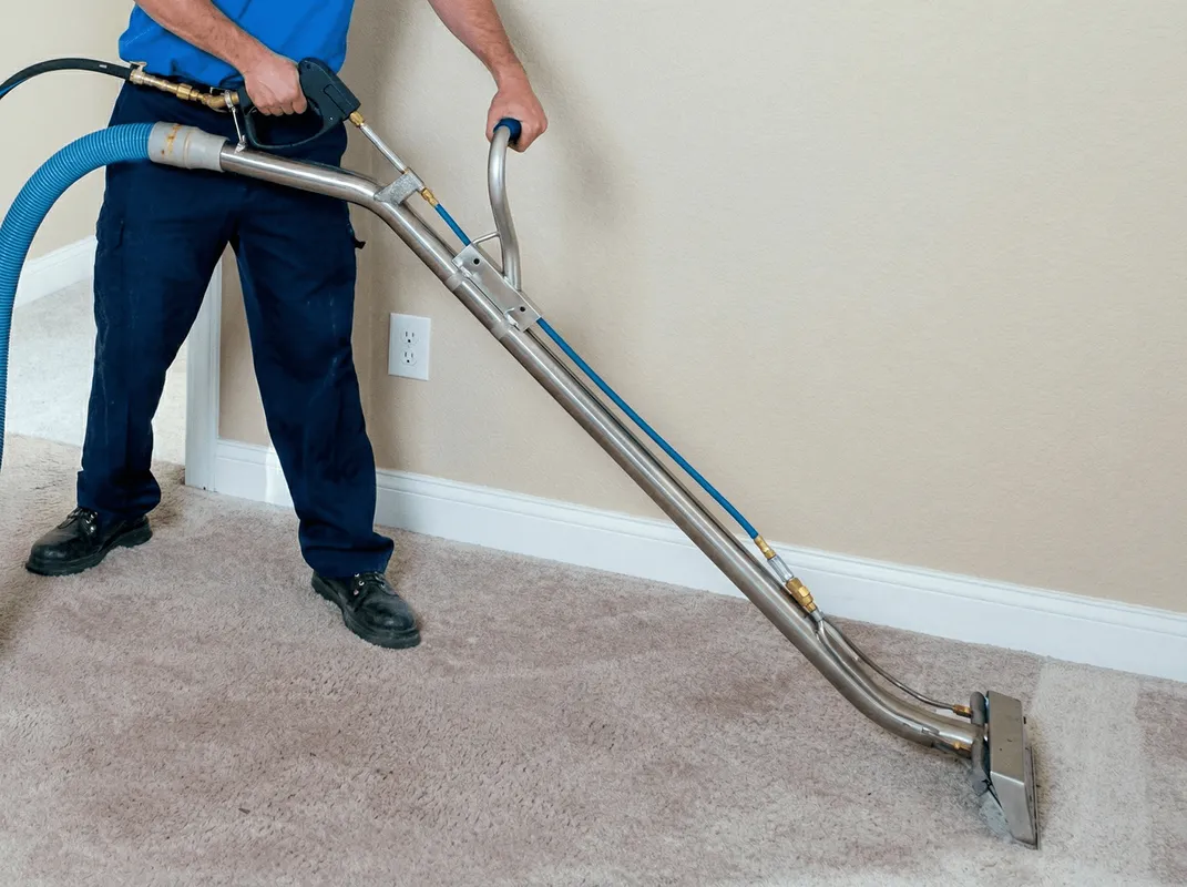 Professional operating a liquid removal machine on a carpeted floor in Chicago, IL